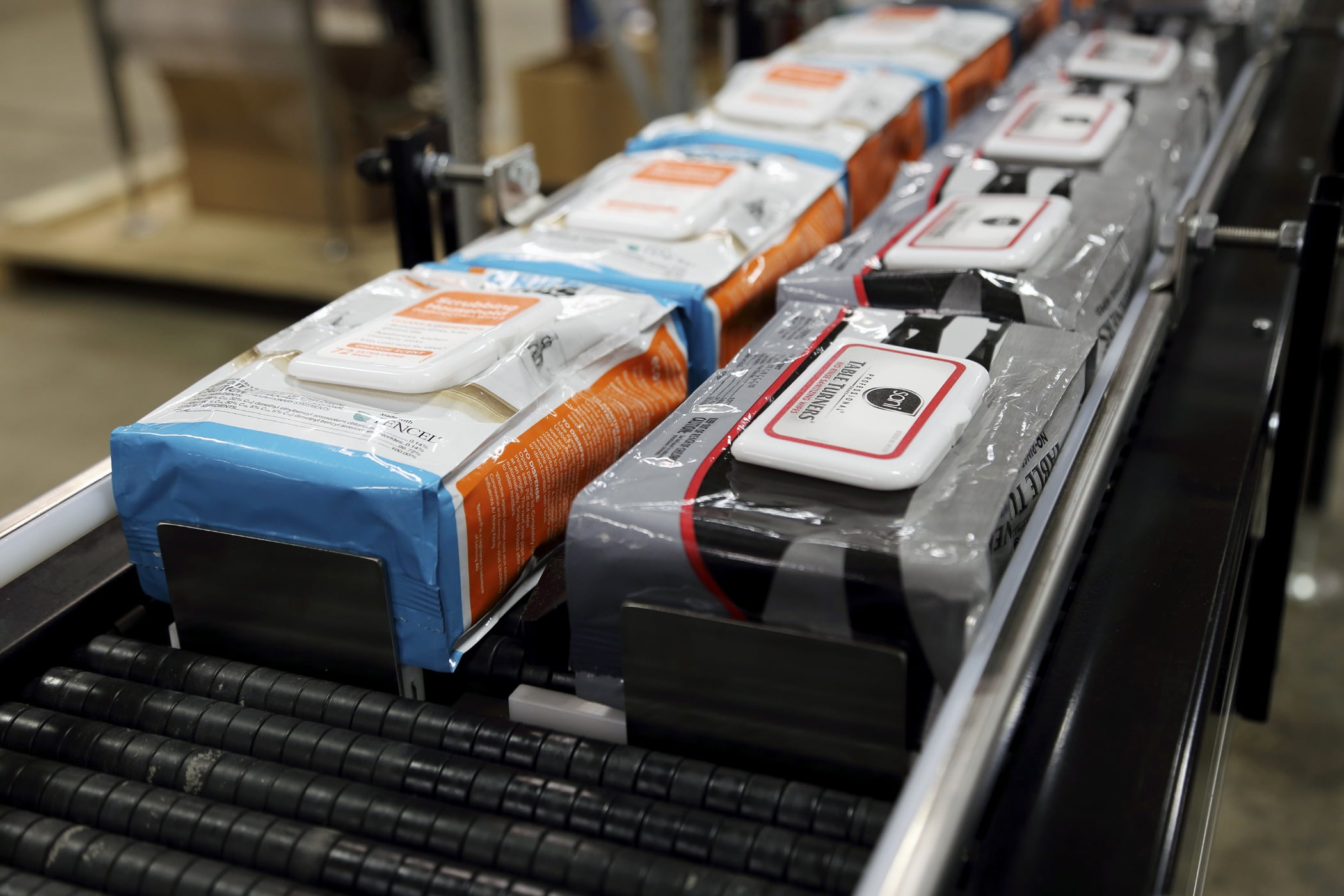 Sanitizing wipes on a conveyor belt: The demand for sanitizing wet wipes has exploded with COVID-19.