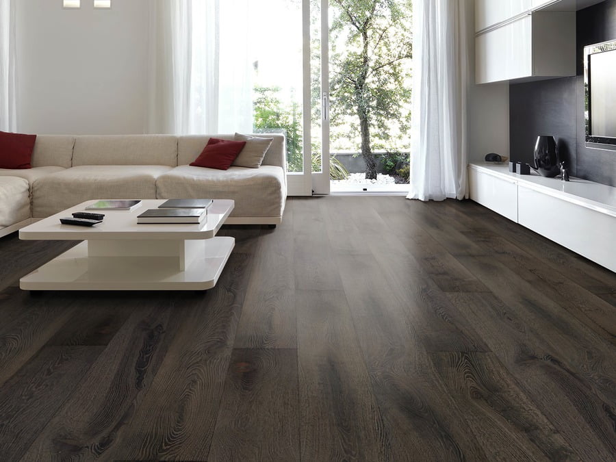 The base color of Burnt Oak is a dark charcoal. The name is a direct description of how this floor is produced. After an aggressive torching of the raw European Oak material, each plank is then cooled with water. Next a wire brush texture is applied, exposing the grain pattern which softens the overall look of this dark floor, while bringing out lighter brown tones.  A final application of natural oils enhances the visual.