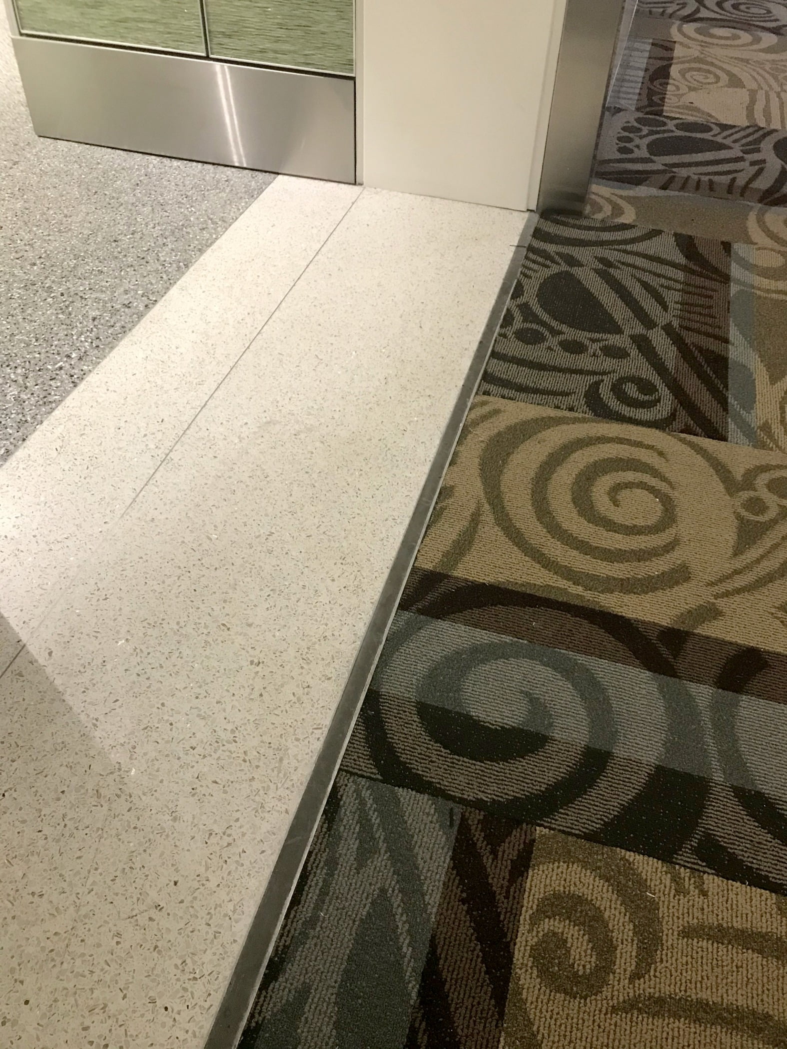 Balco floor pan expansion joint cover and flush mounted wall and ceiling expansion joint covers create a seamless transition and coordinated aesthetic in the Baggage Claim area at the new BNA Vision addition of the Nashville International Airport in Nashville, Tennessee.