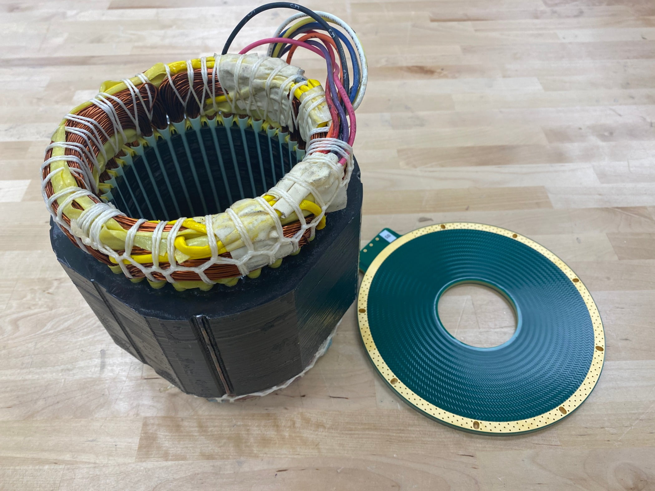 This silicon-based printed circuit board stator right is much easier to mass-produce than a traditional heavy iron core stator left. 