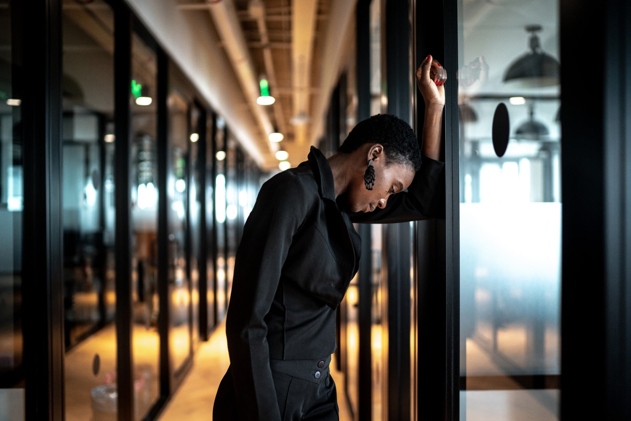 Worried young businesswoman at corridor office