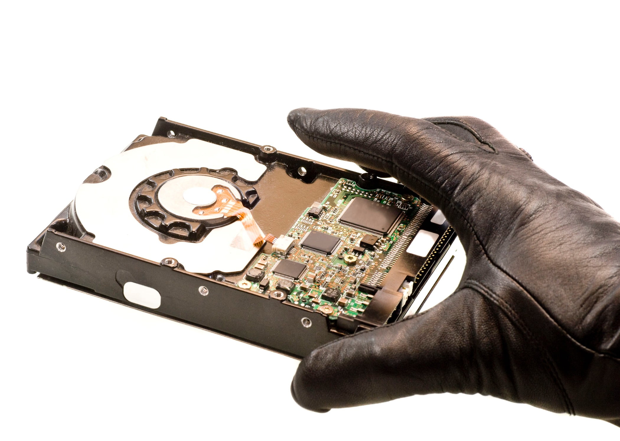 stealing data hand in black gloves taking hard drive