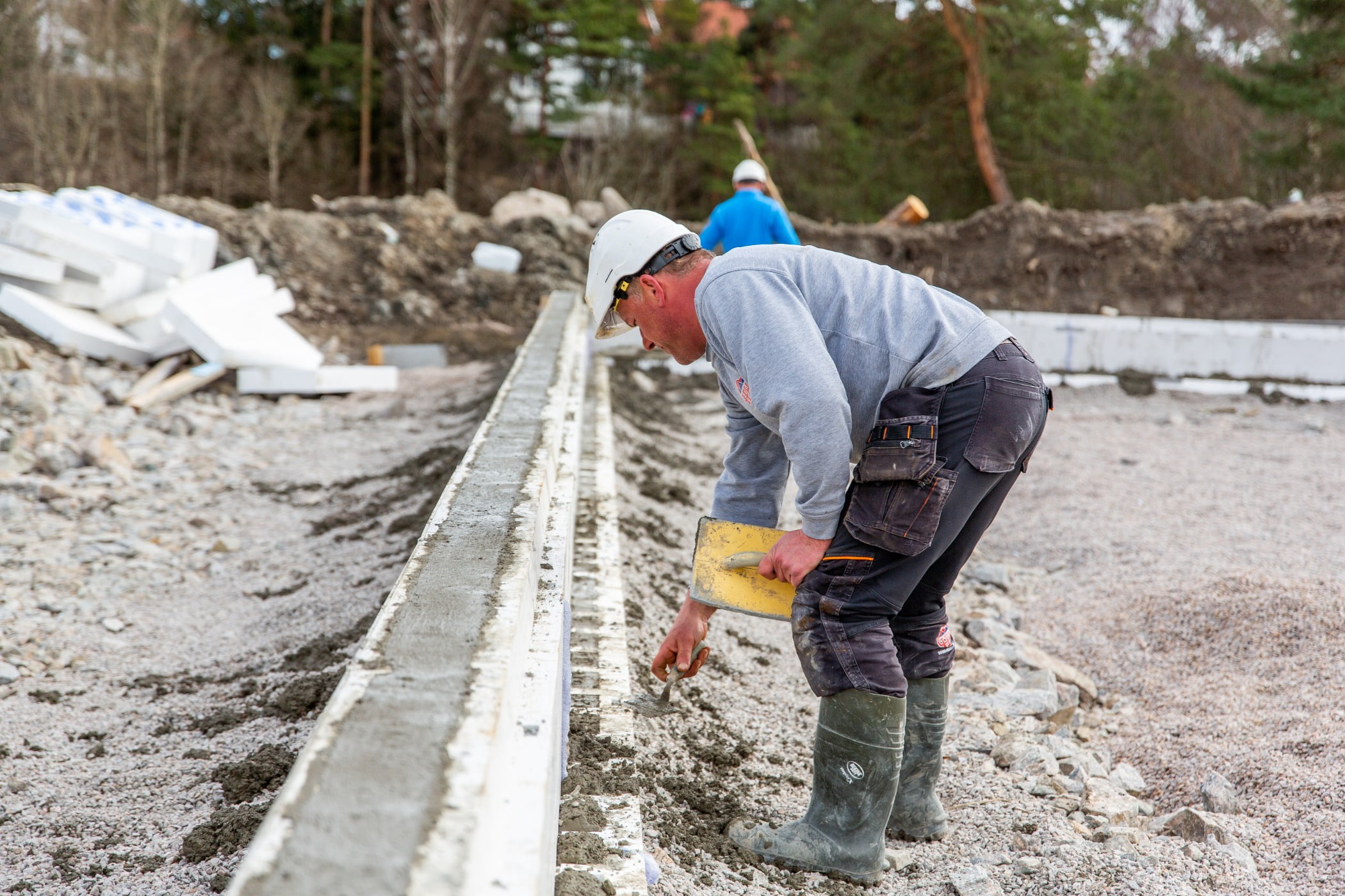 Hard hat, High-visibility clothing, Road surface, Workwear, Tradesman, Tree, Asphalt, Wood, Track, Engineer
